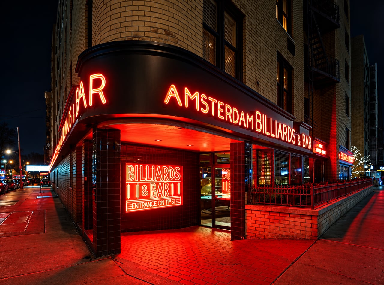 Amsterdam Billiards exterior at night in New York City, its red neon around the corner of the building