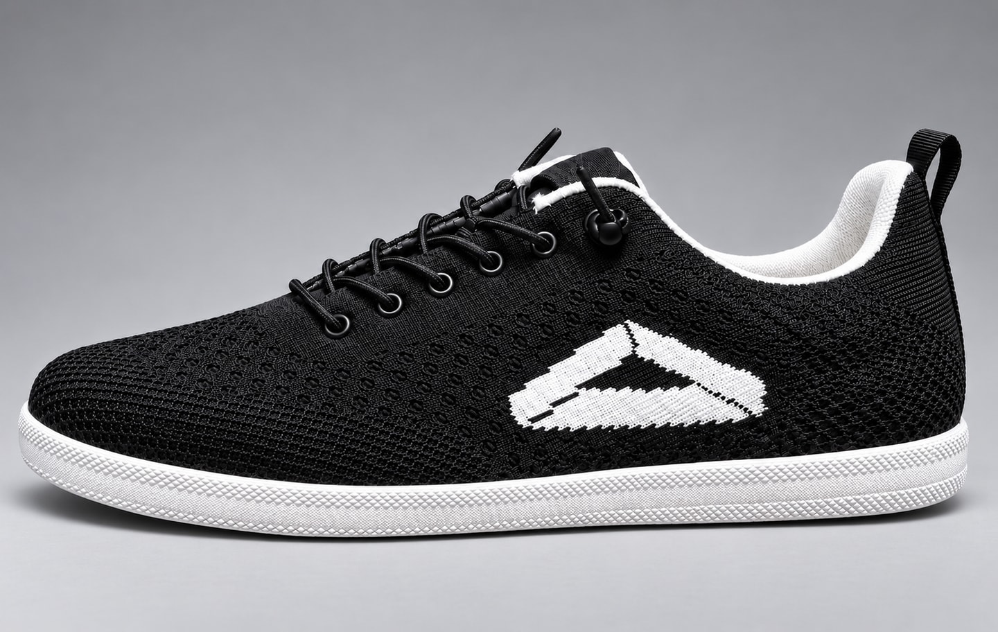 The Rack Runner shoe in side profile: black knit upper with the white Rack Runner mark, black laces, white sole